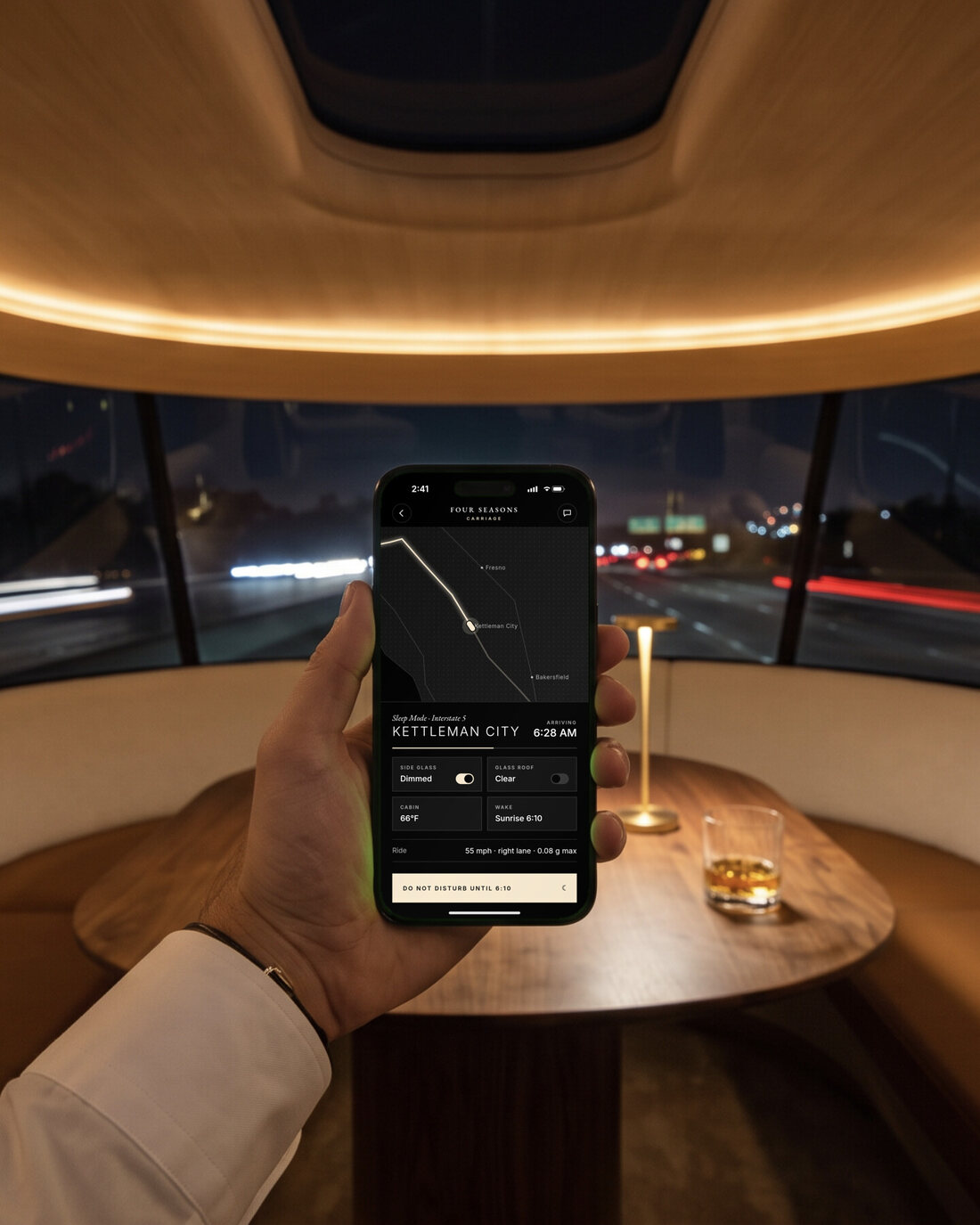 A hand holding an iPhone showing the Carriage app: ride