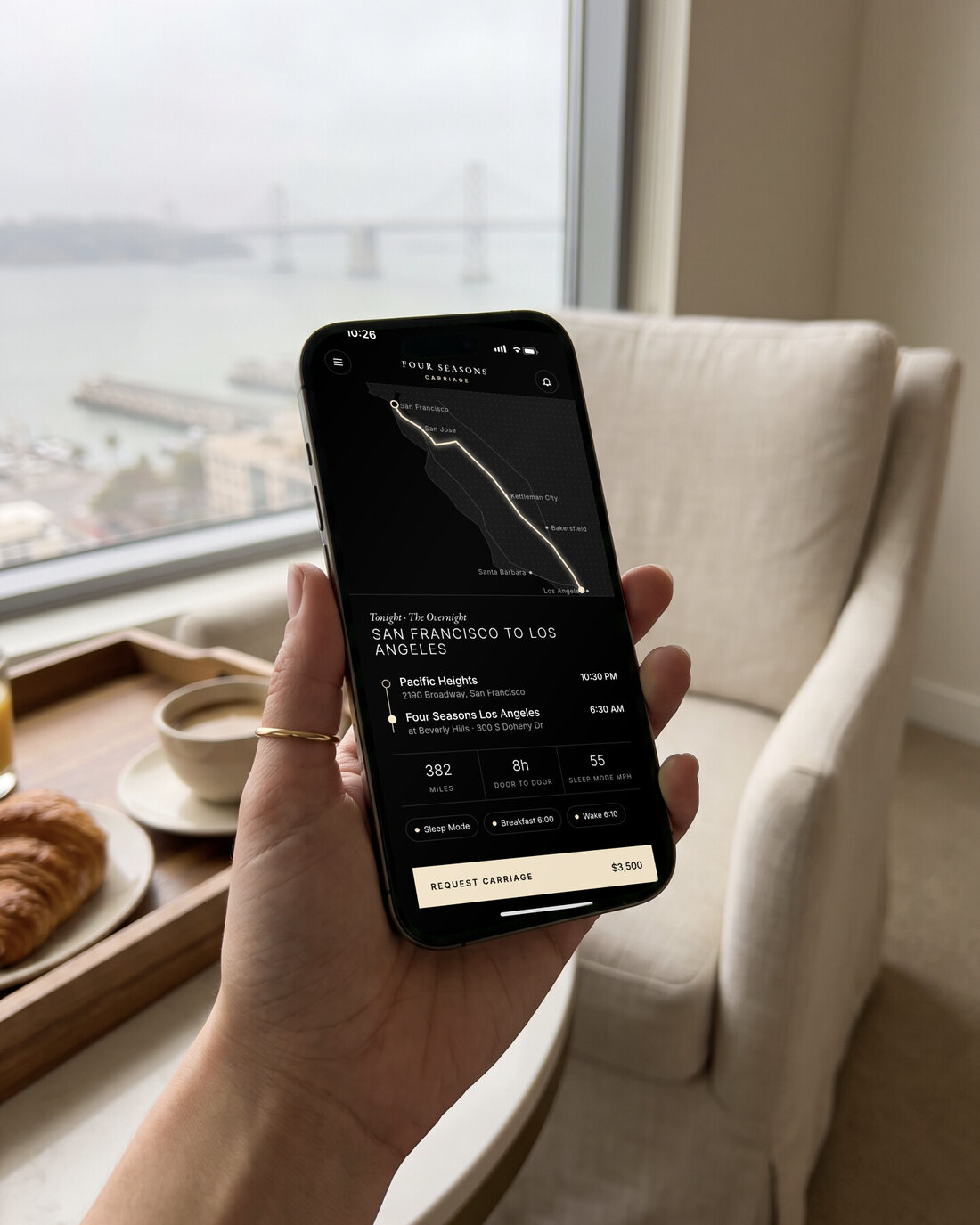 A hand holding an iPhone showing the Carriage app: plan