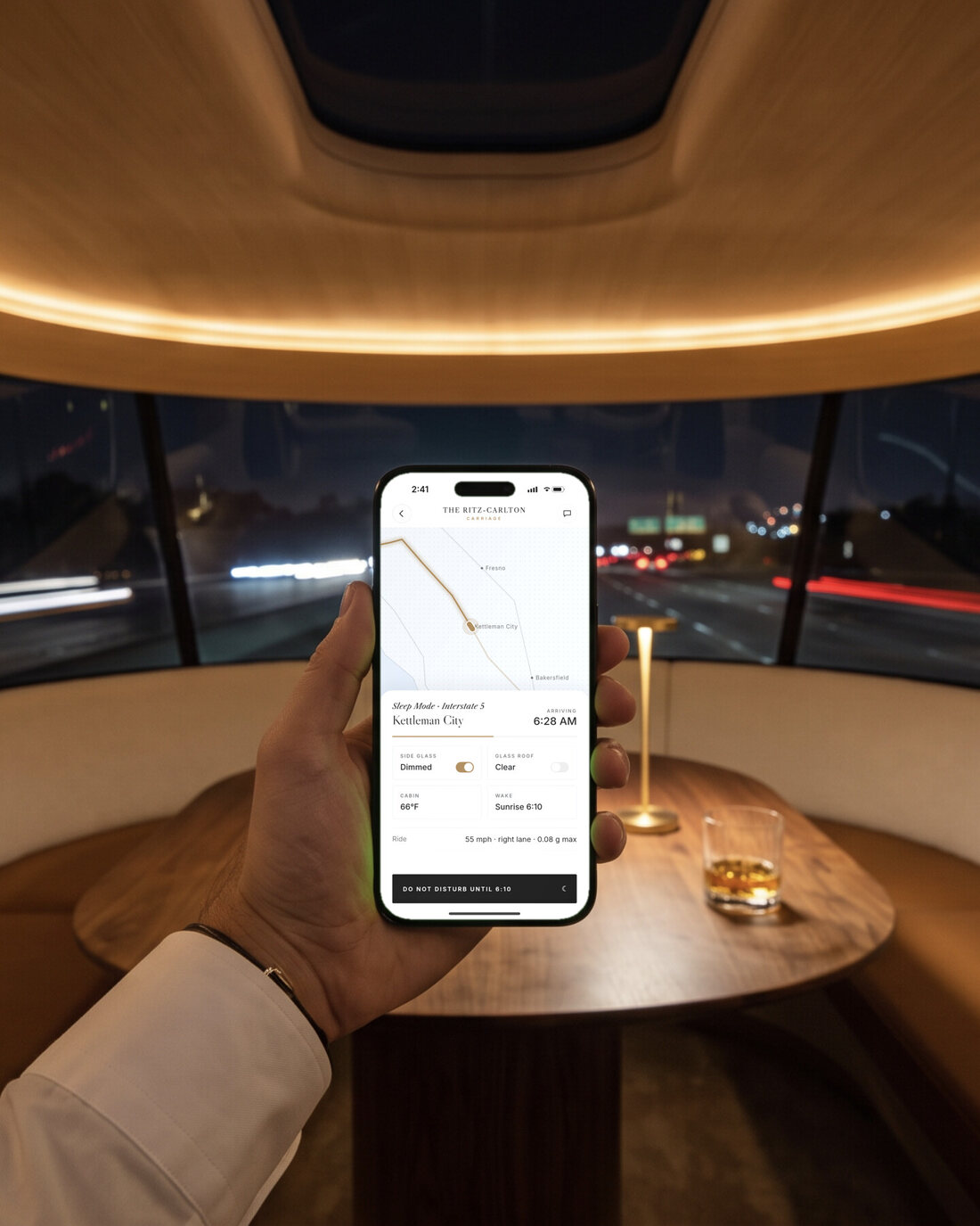 A hand holding an iPhone showing the Carriage app: ride