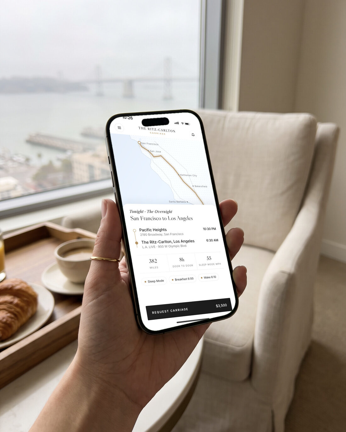A hand holding an iPhone showing the Carriage app: plan
